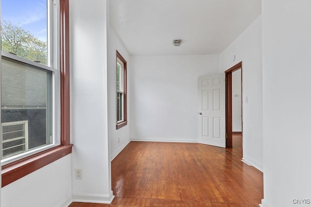 410 John St, Syracuse, NY 13208 - spare room featuring wood finished floors, healthy amount of natural light, and baseboards