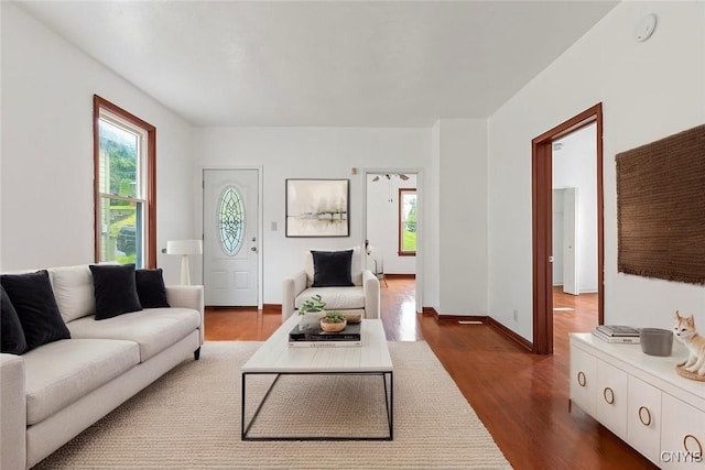 410 John St, Syracuse, NY 13208 - living area with plenty of natural light, dark wood-style flooring, and baseboards