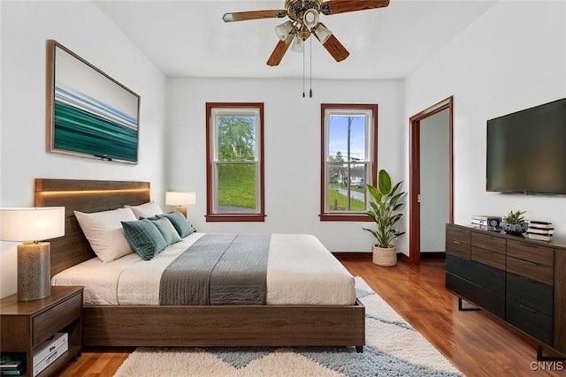 410 John St, Syracuse, NY 13208 - bedroom featuring wood finished floors, a ceiling fan, and baseboards