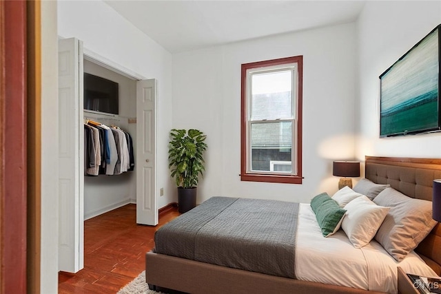 410 John St, Syracuse, NY 13208 - bedroom featuring dark wood-style floors, a closet, and a walk in closet