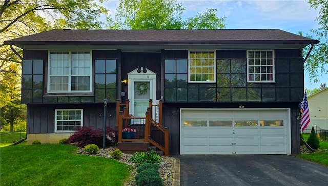 11 Cherry Cir, Erwin, NY 14870 - view of front of home with asphalt driveway, an attached garage, a front lawn, and board and batten siding