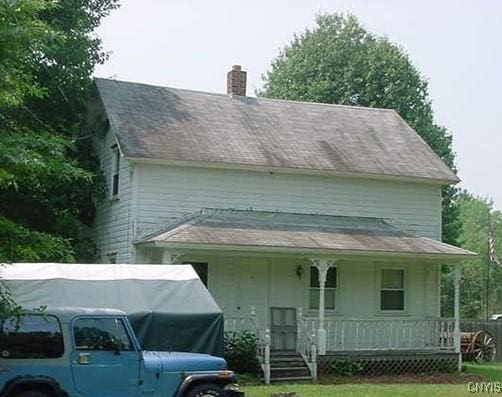67 Avery Rd, Constantia, NY 13044 - view of front facade featuring a porch, a chimney, and a front yard