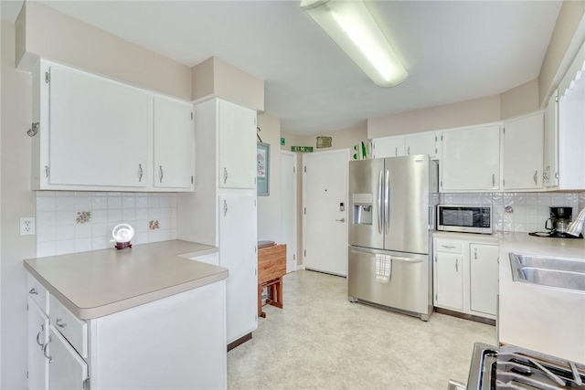 39 Ingram Dr, Gates, NY 14624 - kitchen with stainless steel fridge, light countertops, backsplash, and a sink