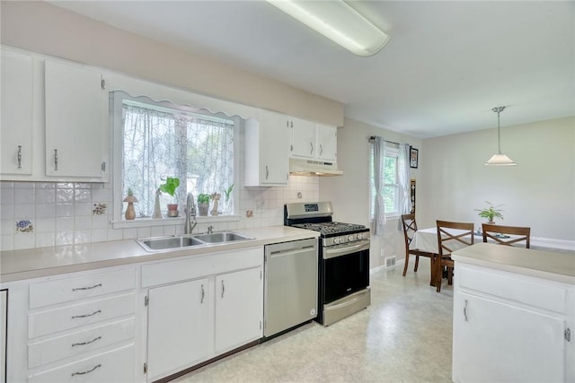 39 Ingram Dr, Gates, NY 14624 - kitchen featuring appliances with stainless steel finishes, under cabinet range hood, a sink, backsplash, and white cabinets