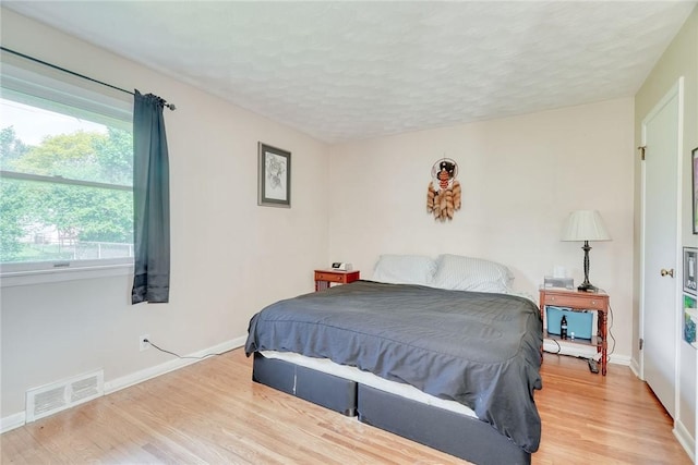 39 Ingram Dr, Gates, NY 14624 - bedroom with light wood-type flooring, baseboards, and a textured ceiling