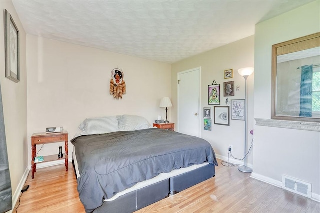 39 Ingram Dr, Gates, NY 14624 - bedroom with wood finished floors, baseboards, and a textured ceiling