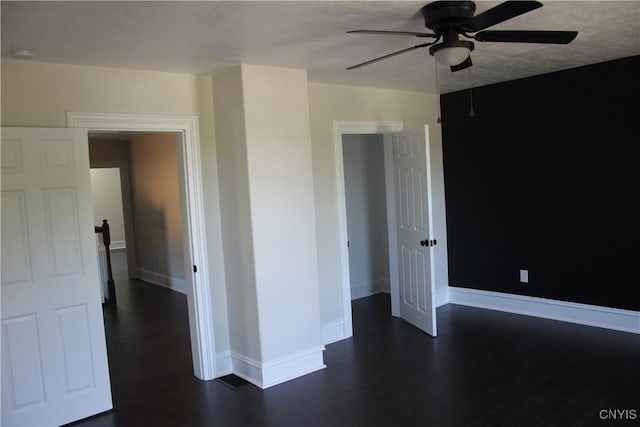 8766 N Main St, Le Ray, NY 13637 - unfurnished bedroom with dark wood finished floors, baseboards, and a ceiling fan