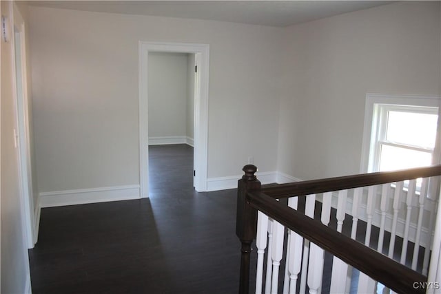 8766 N Main St, Le Ray, NY 13637 - hallway featuring dark wood-style floors, baseboards, and an upstairs landing