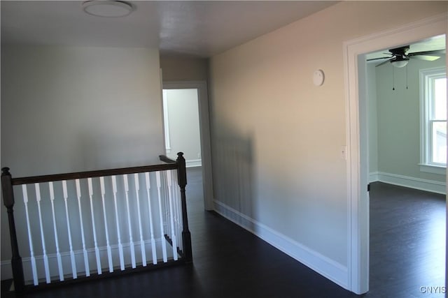 8766 N Main St, Le Ray, NY 13637 - corridor with an upstairs landing, dark wood-type flooring, and baseboards