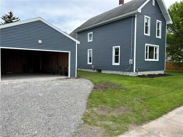 8766 N Main St, Le Ray, NY 13637 - view of side of home featuring a chimney, a garage, a lawn, an outdoor structure, and roof with shingles