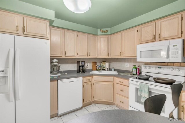 950 Hopkins Rd Unit B, Amherst, NY 14221 - kitchen with white appliances, light brown cabinets, light tile patterned floors, a sink, and tasteful backsplash