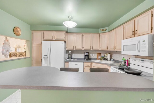 950 Hopkins Rd Unit B, Amherst, NY 14221 - kitchen with white appliances, a peninsula, a sink, and light countertops