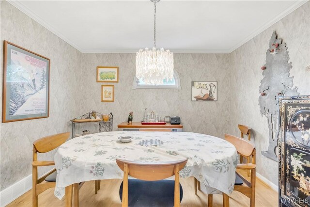 950 Hopkins Rd Unit B, Amherst, NY 14221 - dining area with wood finished floors, a chandelier, crown molding, and baseboards