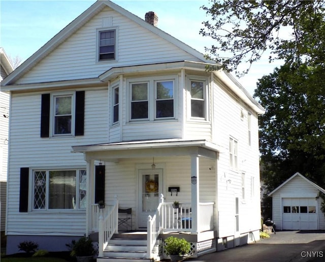 806 Mildred Ave, Utica, NY 13502 - view of front of house with covered porch, an outdoor structure, a chimney, a detached garage, and driveway