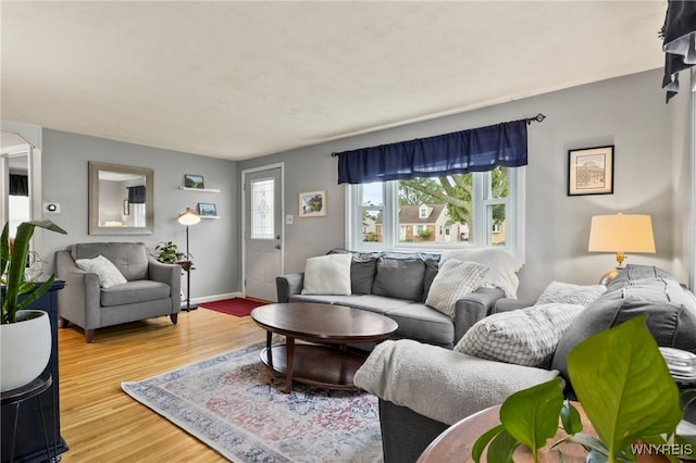1587 Parker Blvd, Tonawanda-Town, NY 14150 - living area featuring plenty of natural light, wood finished floors, and baseboards