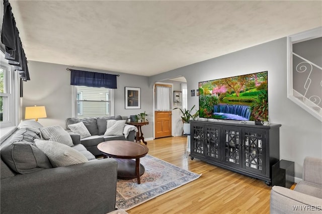 1587 Parker Blvd, Tonawanda-Town, NY 14150 - living area with arched walkways, wood finished floors, and baseboards