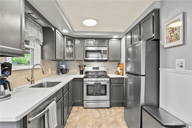 1587 Parker Blvd, Tonawanda-Town, NY 14150 - kitchen with stainless steel appliances, a sink, backsplash, light countertops, and glass insert cabinets