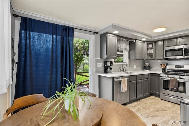 1587 Parker Blvd, Tonawanda-Town, NY 14150 - kitchen with appliances with stainless steel finishes, a sink, gray cabinetry, backsplash, and light countertops