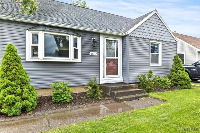 1587 Parker Blvd, Tonawanda-Town, NY 14150 - view of front of property with a shingled roof and a front yard