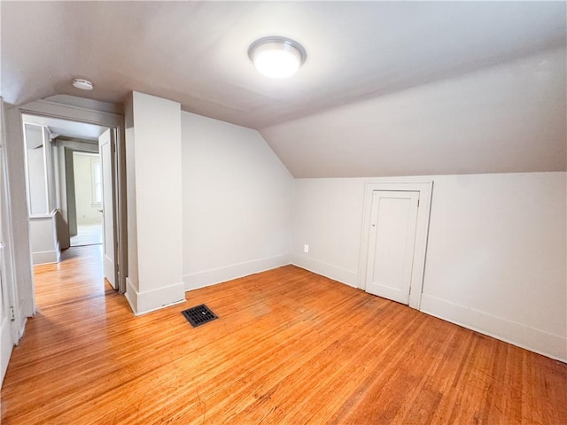 257 Haviland Park, Greece, NY 14616 - additional living space with vaulted ceiling, baseboards, and light wood finished floors