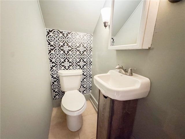257 Haviland Park, Greece, NY 14616 - half bath with toilet, tile patterned floors, vaulted ceiling, and a sink