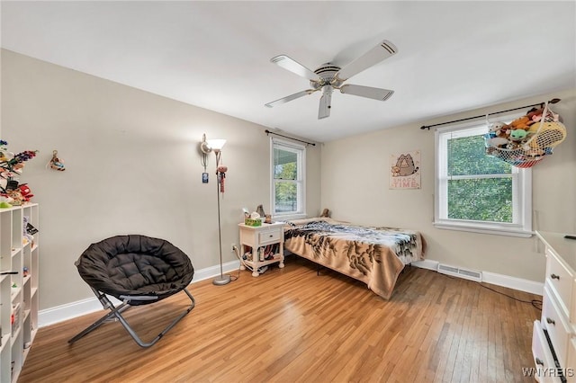 8918 Hurlburt Ln, Clarence, NY 14031 - bedroom featuring light wood finished floors, multiple windows, and baseboards