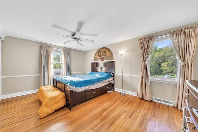 8918 Hurlburt Ln, Clarence, NY 14031 - bedroom with light wood finished floors, multiple windows, and baseboards