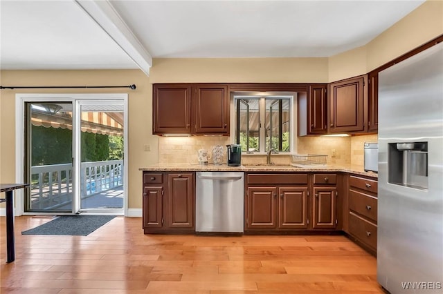 8918 Hurlburt Ln, Clarence, NY 14031 - kitchen with appliances with stainless steel finishes, a sink, light wood finished floors, and decorative backsplash