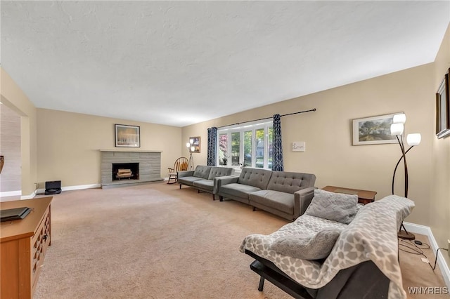 8918 Hurlburt Ln, Clarence, NY 14031 - living room with light colored carpet, baseboards, and a stone fireplace