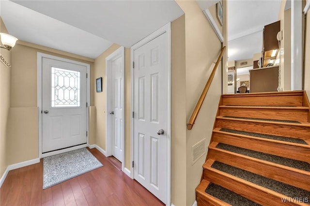 8918 Hurlburt Ln, Clarence, NY 14031 - entryway with wood finished floors, baseboards, and stairs