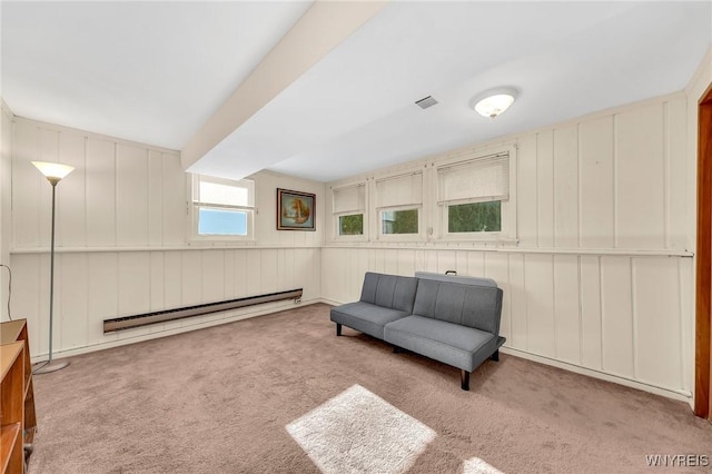 8918 Hurlburt Ln, Clarence, NY 14031 - sitting room with baseboard heating, carpet floors, and a decorative wall