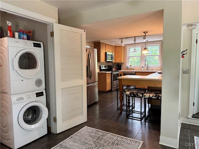 22 Hamilton St, Hamilton, NY 13346 - washroom with stacked washing machine and dryer and dark tile patterned flooring