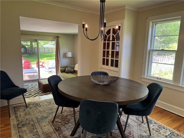 22 Hamilton St, Hamilton, NY 13346 - dining space with wood finished floors, a chandelier, healthy amount of natural light, ornamental molding, and baseboards