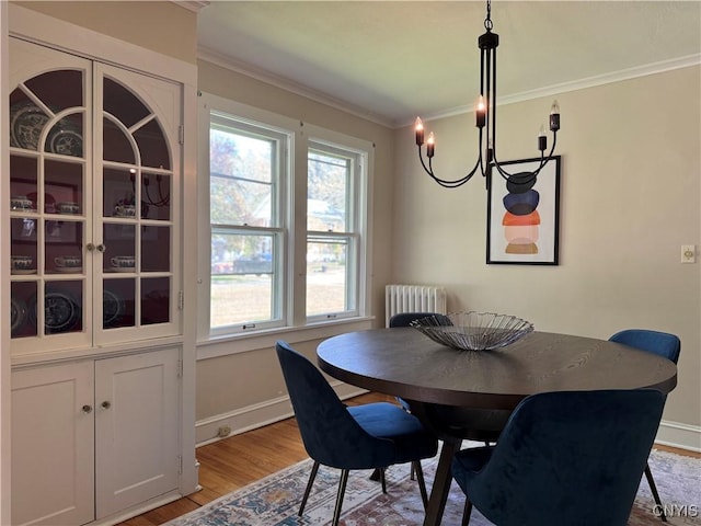 22 Hamilton St, Hamilton, NY 13346 - dining space with crown molding, light wood finished floors, radiator heating unit, a chandelier, and baseboards