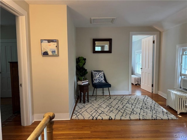 22 Hamilton St, Hamilton, NY 13346 - sitting room with radiator, wood finished floors, baseboards, and attic access