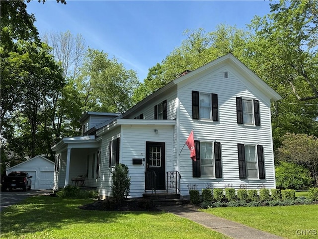 22 Hamilton St, Hamilton, NY 13346 - view of front facade featuring an outdoor structure, a front lawn, and a garage