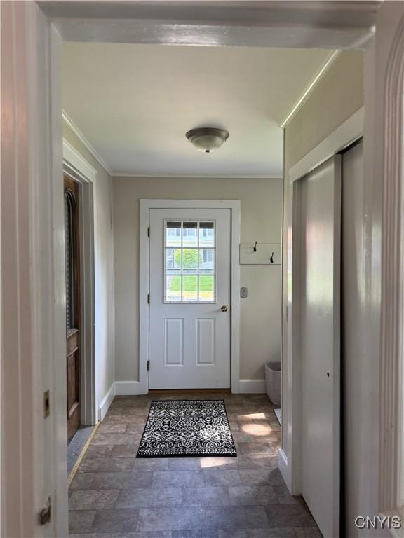 22 Hamilton St, Hamilton, NY 13346 - entryway with baseboards, stone finish flooring, and crown molding