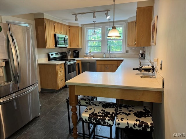 22 Hamilton St, Hamilton, NY 13346 - kitchen featuring stainless steel appliances, light countertops, a sink, and a peninsula