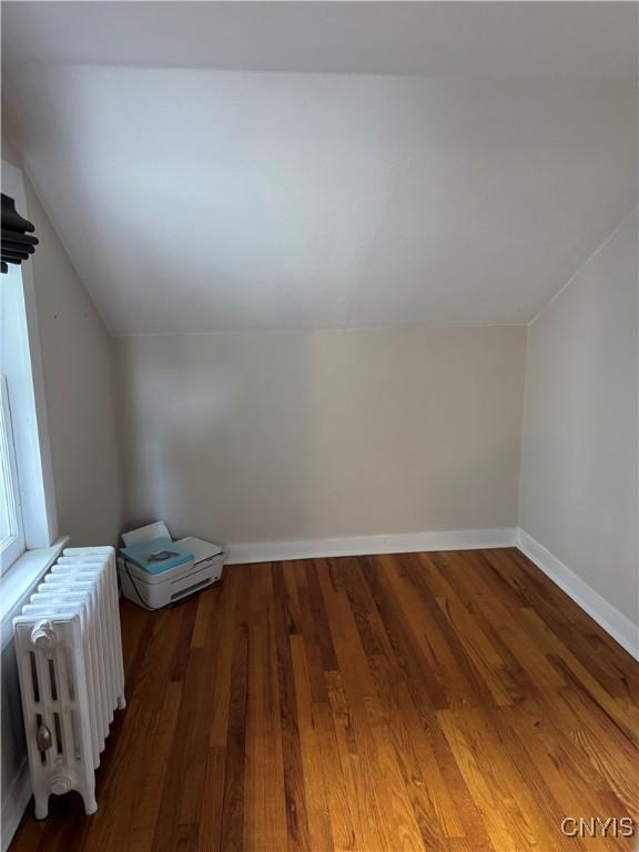 22 Hamilton St, Hamilton, NY 13346 - bonus room with radiator heating unit, lofted ceiling, wood finished floors, and baseboards