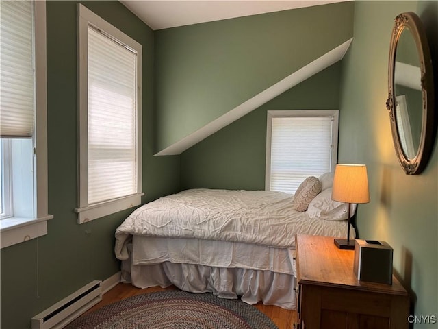22 Hamilton St, Hamilton, NY 13346 - bedroom with a baseboard radiator, wood finished floors, and multiple windows