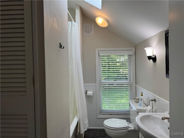 22 Hamilton St, Hamilton, NY 13346 - bathroom featuring a sink, toilet, a wainscoted wall, vaulted ceiling, and tile patterned floors
