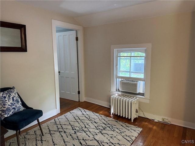 22 Hamilton St, Hamilton, NY 13346 - living area with radiator heating unit, wood finished floors, baseboards, and cooling unit
