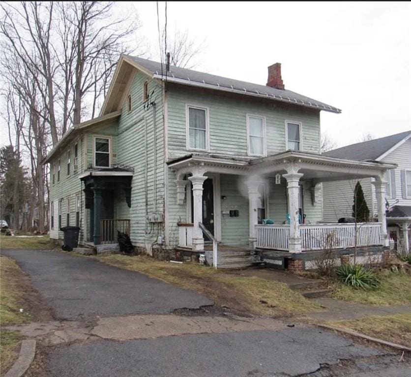 96 Water St, Lyons, NY 14489 - view of front of home featuring a chimney and covered porch