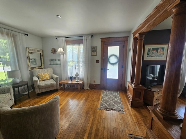 6207 Knickerbocker Rd, Ontario, NY 14519 - foyer entrance with decorative columns, healthy amount of natural light, hardwood / wood-style flooring, and baseboards