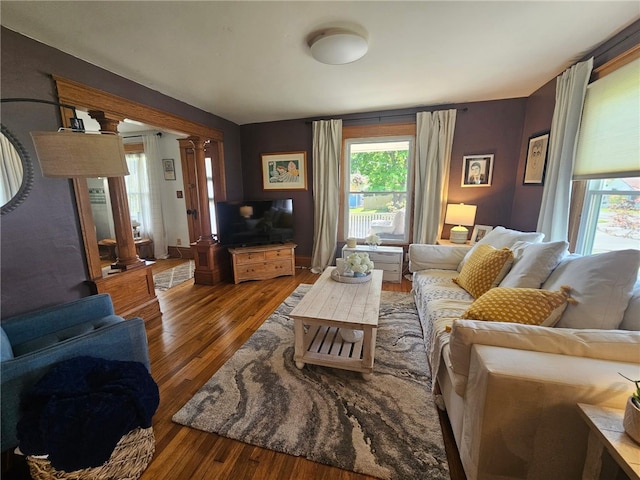 6207 Knickerbocker Rd, Ontario, NY 14519 - living room featuring decorative columns and hardwood / wood-style floors