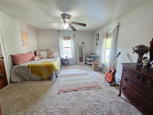 6207 Knickerbocker Rd, Ontario, NY 14519 - carpeted bedroom featuring multiple windows, ceiling fan, and a baseboard heating unit