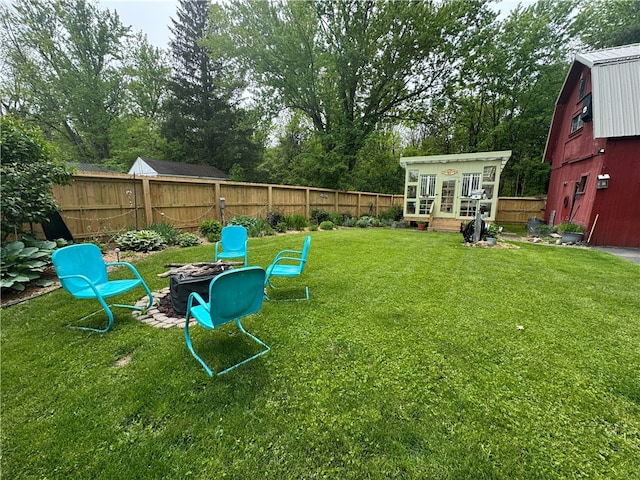 6207 Knickerbocker Rd, Ontario, NY 14519 - view of yard featuring an outdoor fire pit, an outbuilding, and view of wooded area