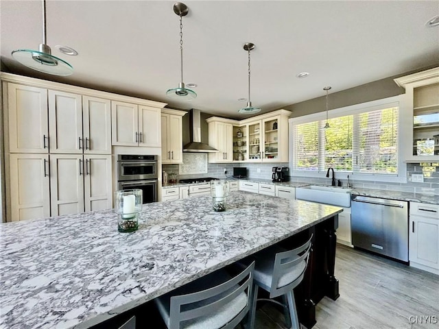 2 Perch Bay Rd, Morristown, NY 13669 - kitchen featuring stainless steel appliances, wall chimney exhaust hood, a sink, decorative backsplash, and recessed lighting