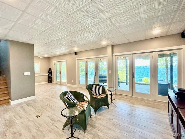 2 Perch Bay Rd, Morristown, NY 13669 - sitting room featuring french doors, light wood-style floors, stairway, baseboards, and an ornate ceiling
