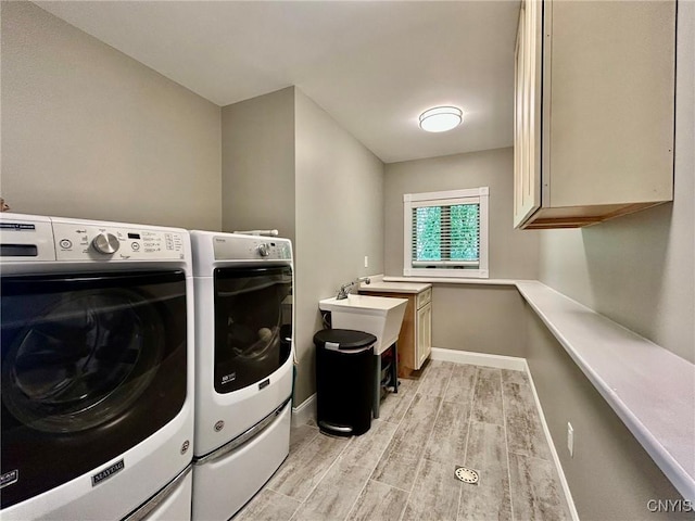 2 Perch Bay Rd, Morristown, NY 13669 - washroom featuring washing machine and dryer, cabinet space, light wood-style flooring, and baseboards
